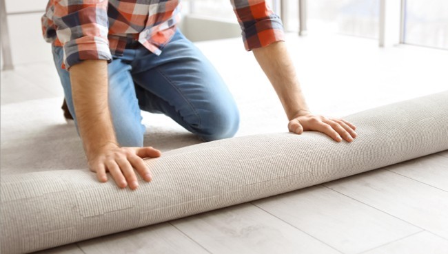 Man rolling carpet for installation | CarpetsPlus COLORTILE & Wholesale Flooring