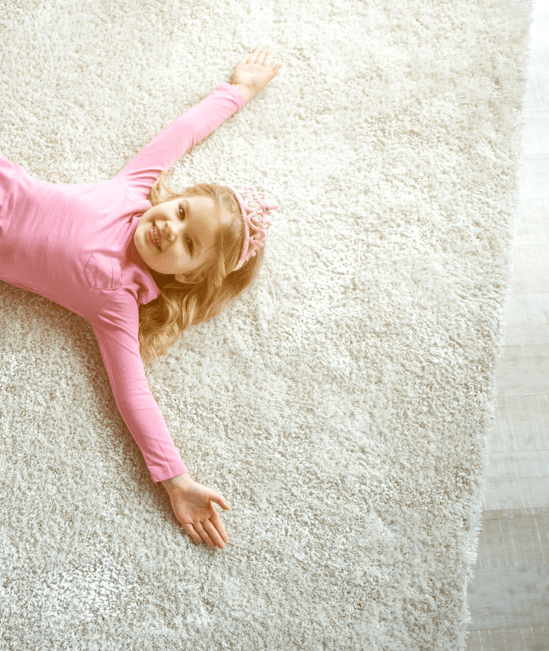 Cute girl laying on rug |   CarpetsPlus COLORTILE & Wholesale Flooring 